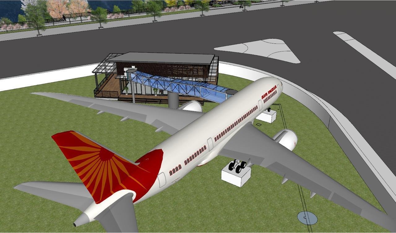 Wide-body airframe positioned on a prepared site with an access bridge and terrace building for restaurant conversion